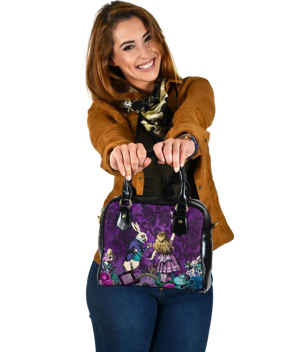 smiling Australian woman showing the viewer her new Gothic cute Alice in Wonderland vegan handbag on a purple damask pattern background
