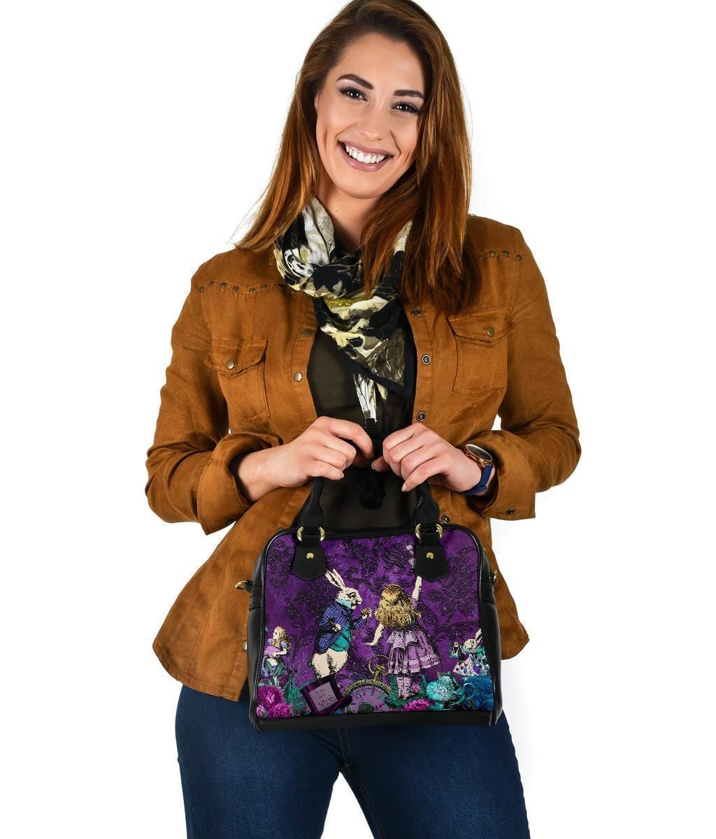 woman holding her birthday gift of the Gothic cute Alice in Wonderland vegan handbag on a purple damask pattern background