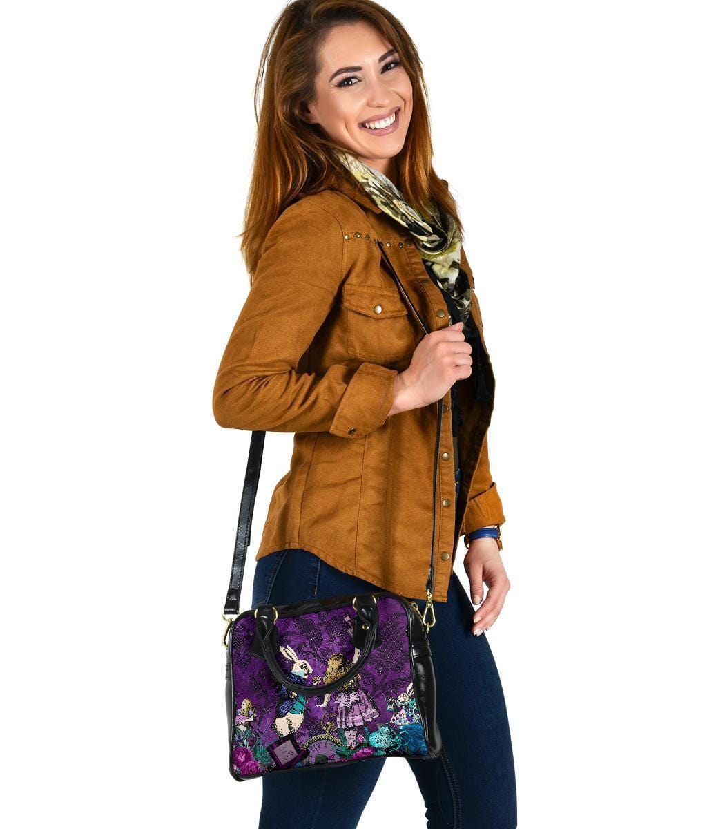 woman wearing the Gothic cute Alice in Wonderland vegan handbag on a purple damask pattern background over her shoulder