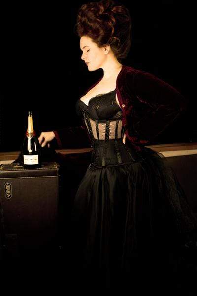 new dark desire black mesh corset worn by corset model Elizabeth Smyth during a quarantine photo shoot, side view