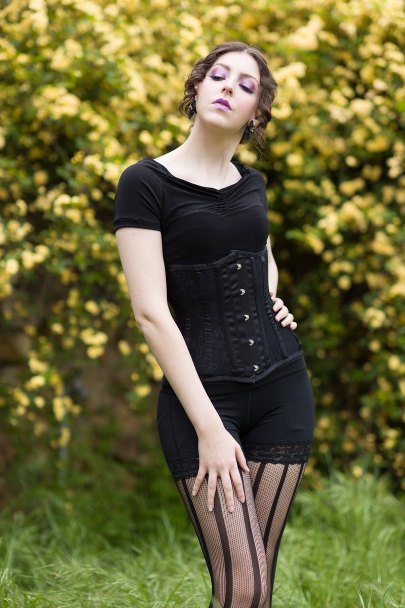 model wearing shape wear fajas with Gallery Serpentine black lace and black satin under bust corset