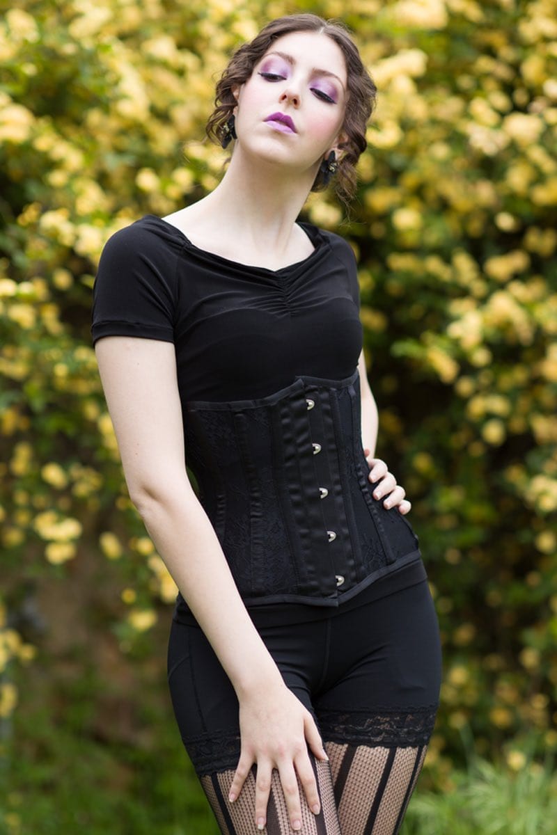 model wearing the new gorgeous black satin and black lace long torso under bust corset at Gallery Serpentine