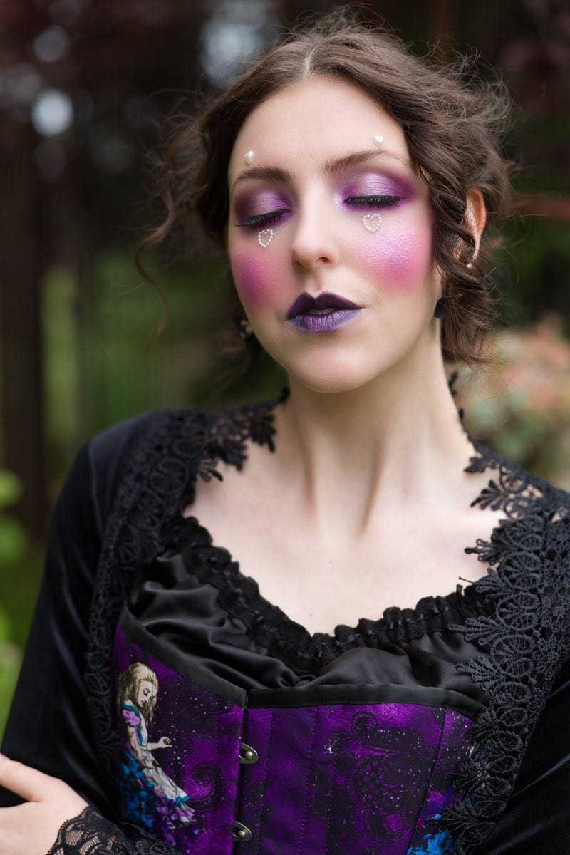Gothic model in rapture over the Gothic purple Alice in Wonderland corset gown by Gallery Serpentine