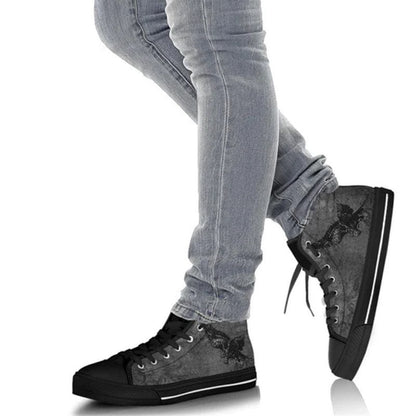 goth guy walking in the super comfortable Storm Raven goth men's high top sneakers featuring a gothic black raven on a grey textured canvas background