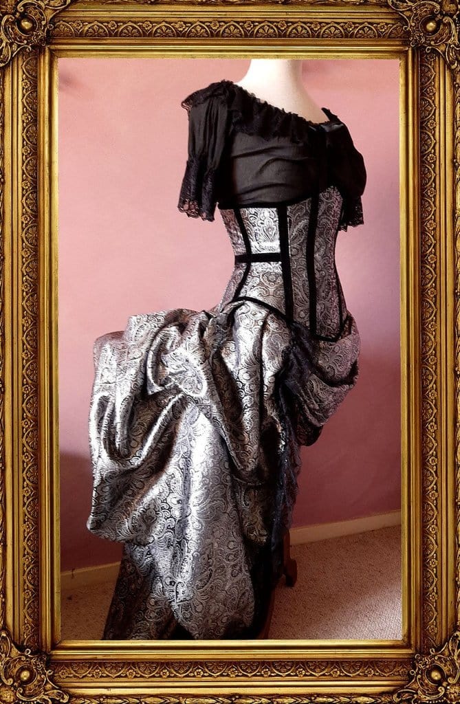 alice in wonderland chemise in black cheesecloth worn with a silver corset and bustle set