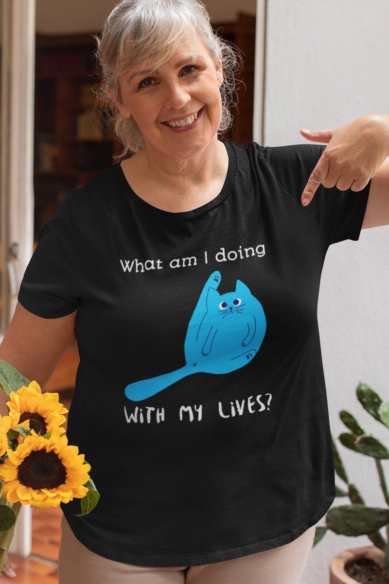 happy smiling middleaged woman with flowers wearing a blue funny 9 lives cat meme t-shirt