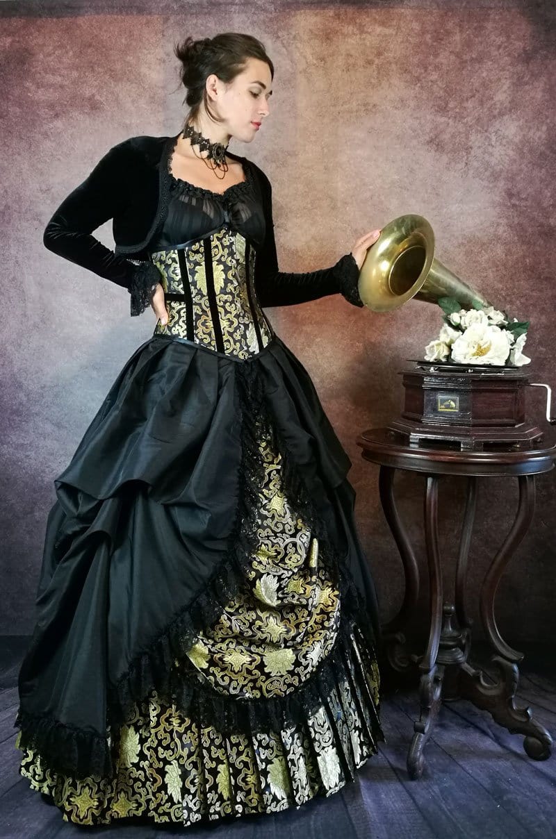 model in a victorian parlour setting with a gramophone wearing the Golden Majestica gothic gown