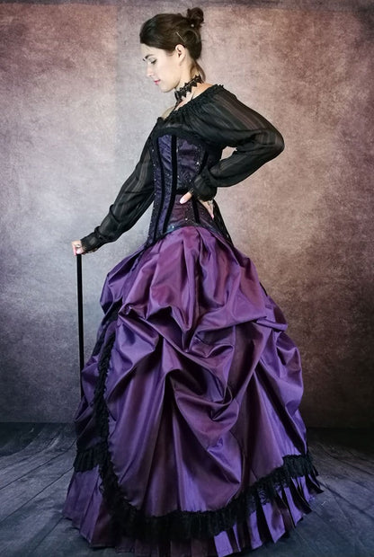 side view of model with a silver top cane wearing a gothic victorian purple corset gown