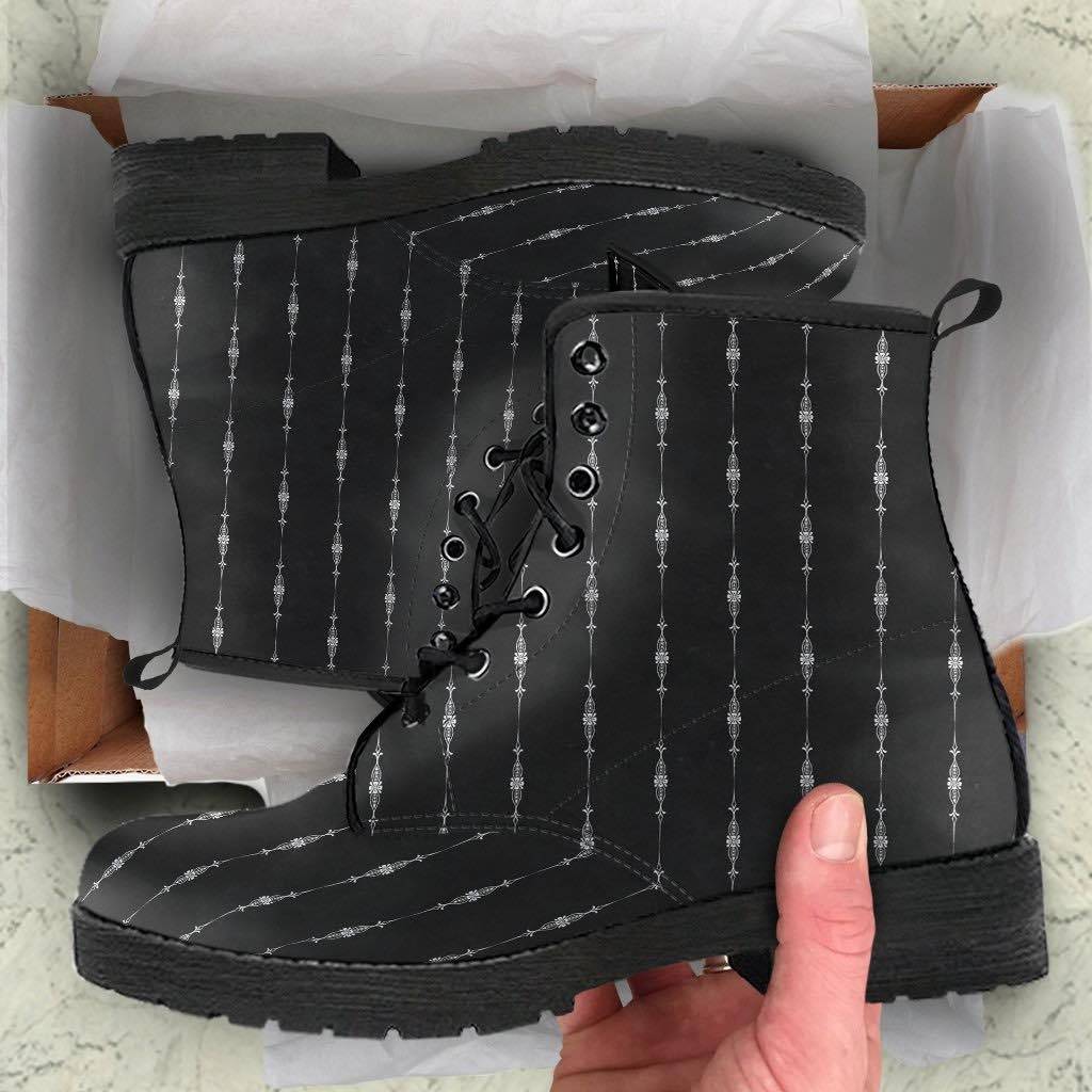 unboxing view of the gothic pinstripe pattern on a pair of black vegan leather boots at Gallery Serpentine