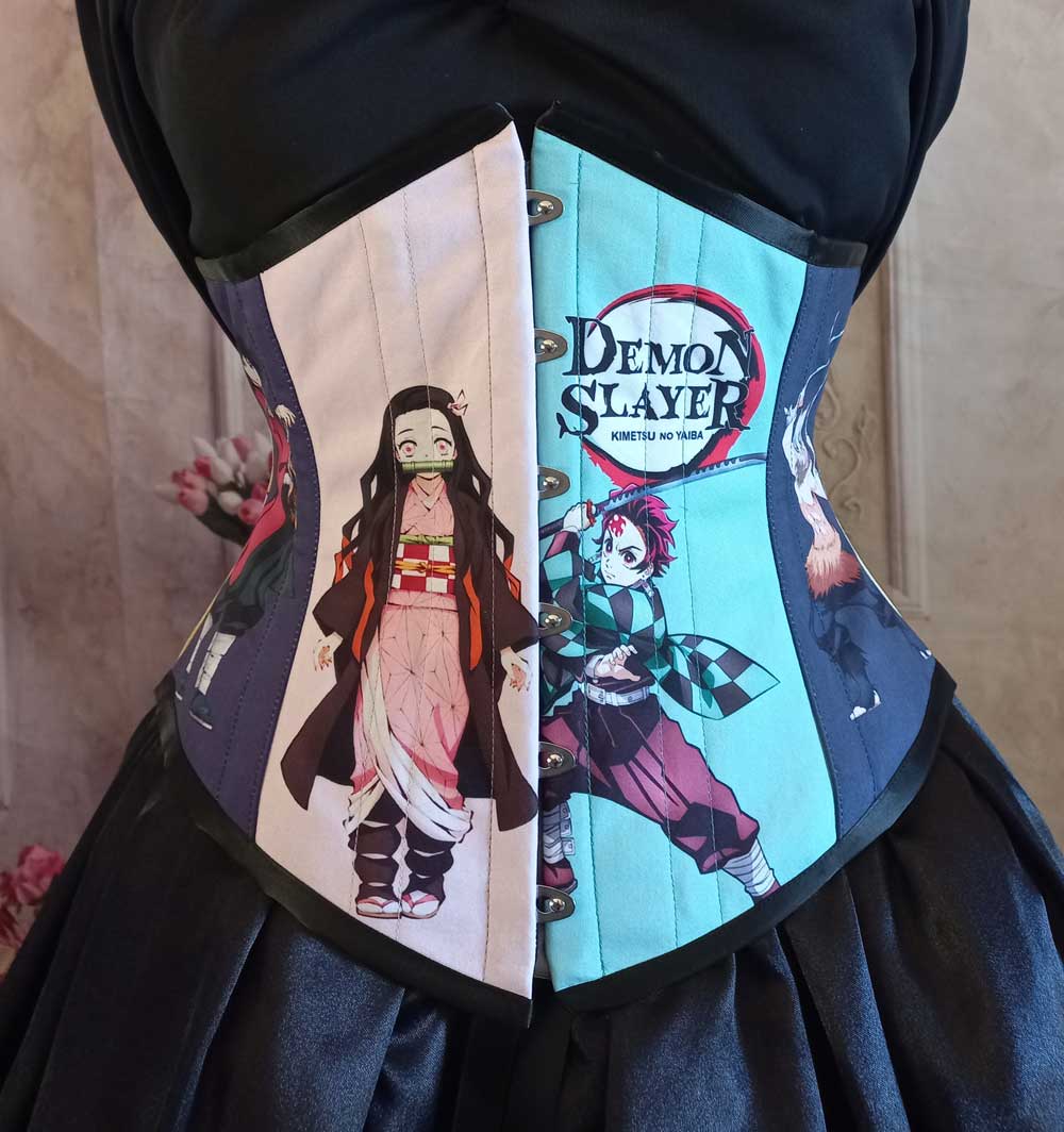 up close on the Demon Slayer corset featuring two of the anime characters
