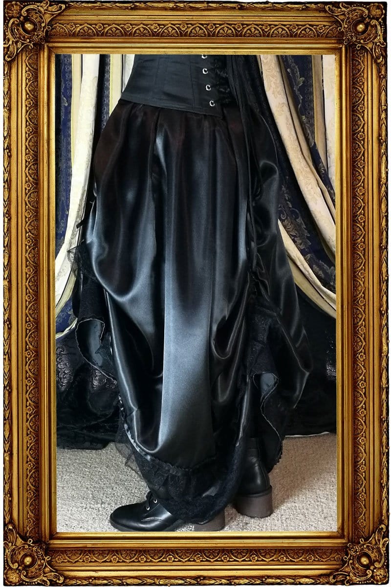 on model showing the neo victorian steampunk style Seraphina skirt side on worn without a hoop skirt underneath in black satin