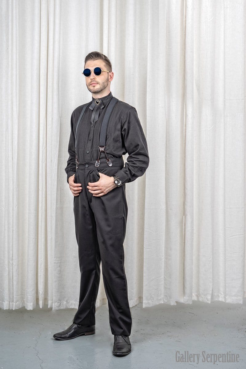 model in the black Tombstone high waisted old wild west men's trousers made of wool blend, worn here with black button on suspender braces