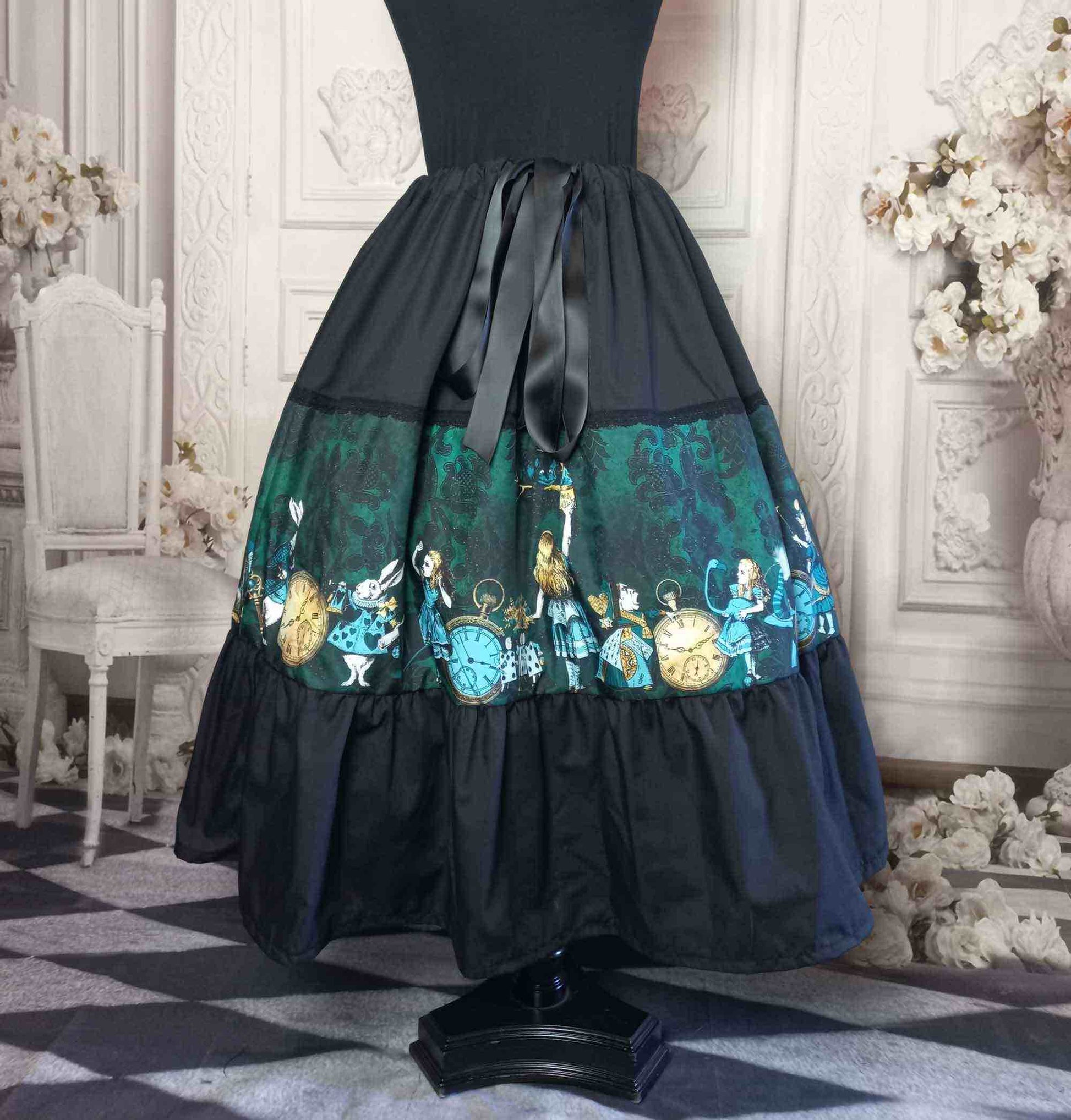 Alice in wonderland print tea length skirt in green and black featuring the characters of the story in aqua and gold