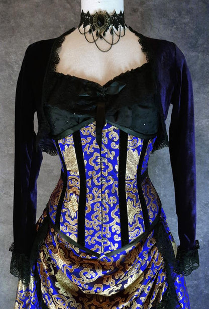royal blue and gold brocade steel boned under bust victorian corset shown with an Alice in Wonderland chemise as the under corset top in black