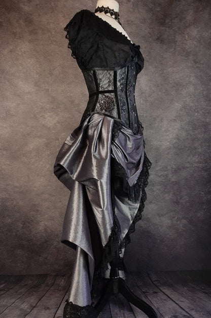 side view of the dark shot silver taffeta victorian style bustle skirt with matching black lace covered australian made steel boned corset shown on a mannequin