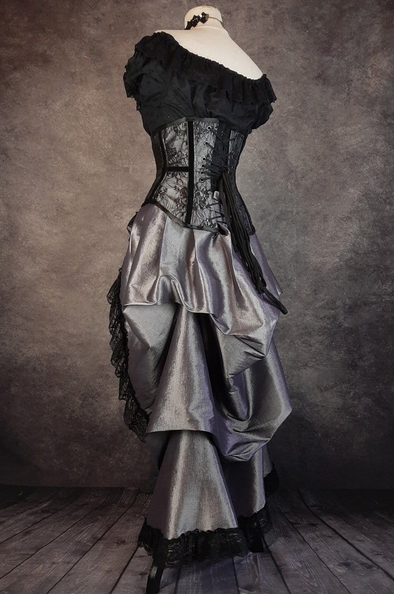back view showing drape in the dark shot silver taffeta victorian style bustle skirt with matching black lace covered australian made steel boned corset shown on a mannequin