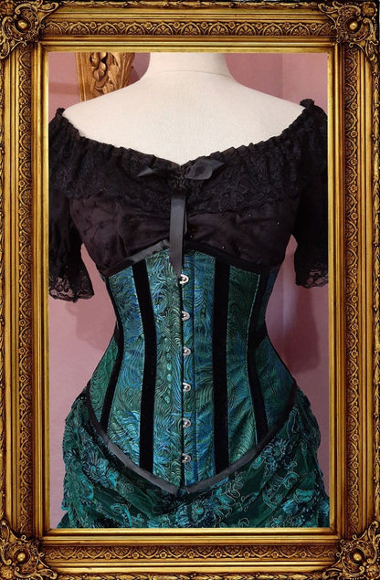 front view of the peacock brocade under bust victorian corset trimmed with black velvet 