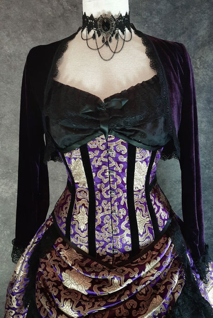 front view of the purple stretch velvet bolero shrug worn here with a chemise in black and a purple and gold corset and skirt