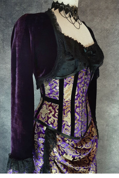side front view of the purple stretch velvet bolero shrug showing the sleeve and how it sits just over the side of an under bust corset 