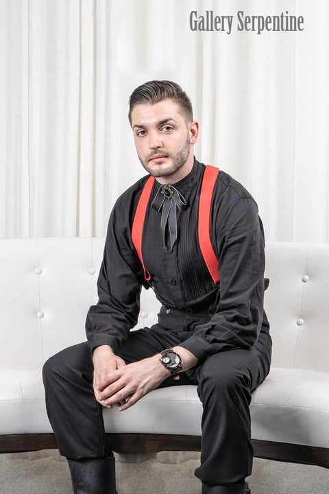 model seated wearing the Tombstone trousers, red button on suspender braces and gothic western ribbon bow tie