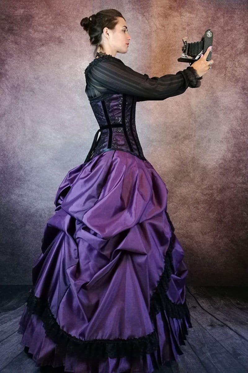 model with a vintage camera wearing the Amethyst Majestica corset gown Gallery Serpentine