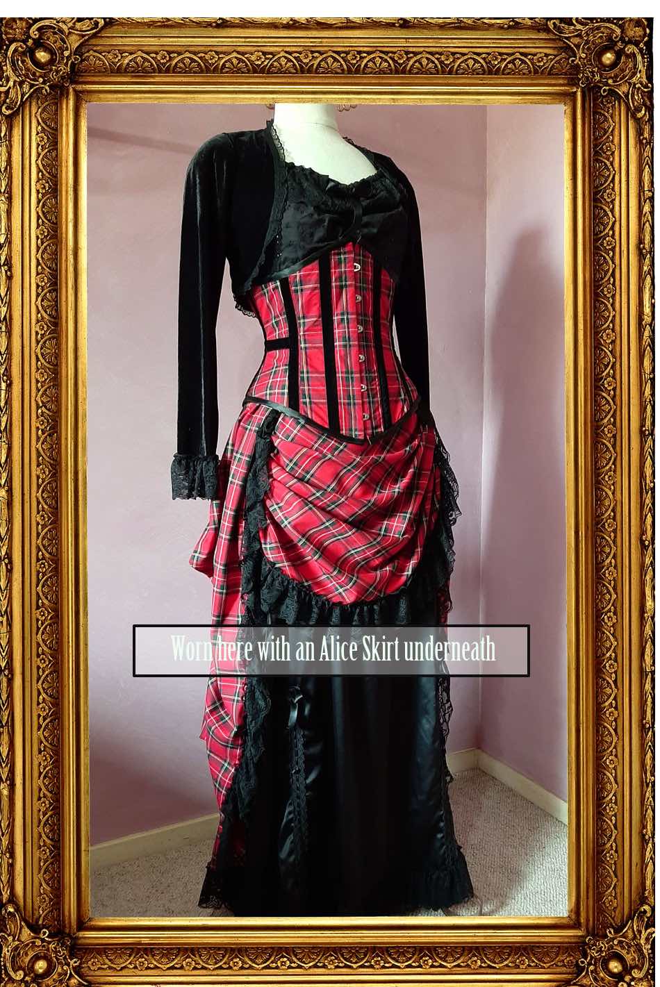 red stewart tartan victorian bustle skirt worn over a black satin full length skirt and with matching corset, black bolero shown from the side front view