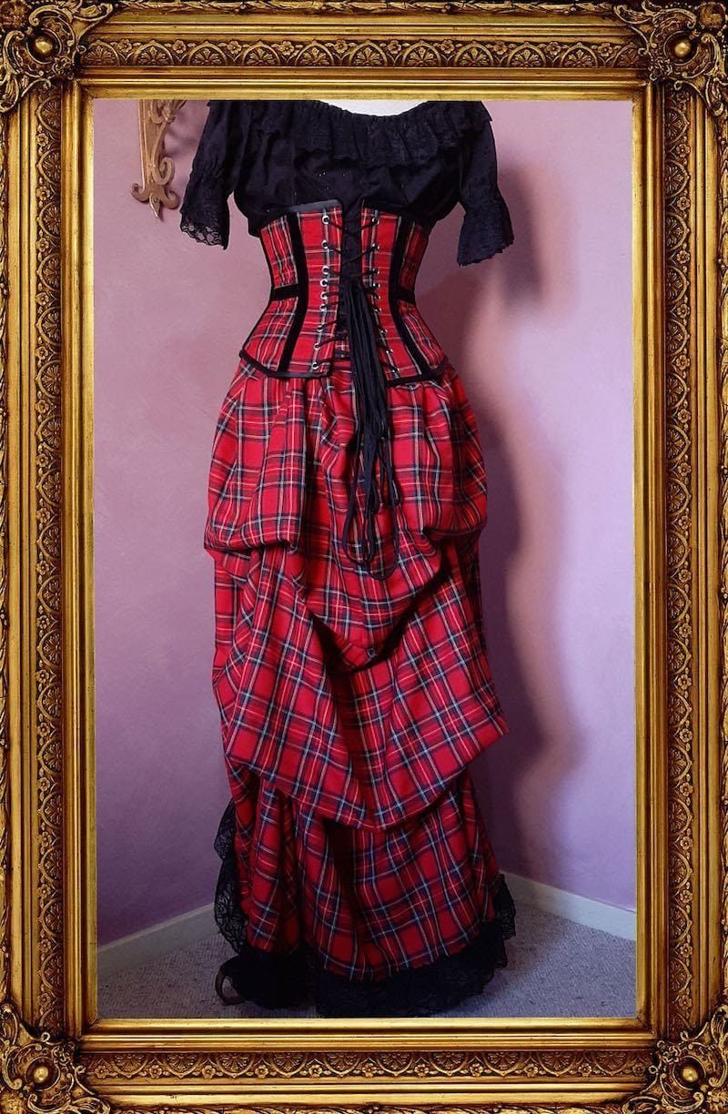 red stewart tartan victorian bustle skirt with matching corset and black bolero shown from the back view with an under corset top in black broderie anglaise included