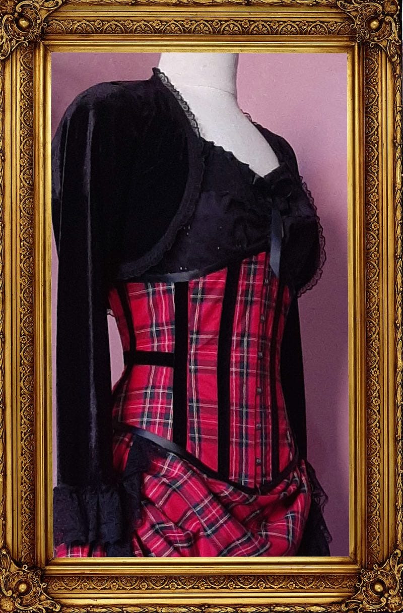 up close side view of the Victorian Punk under bust corset in red stewart tartan trimmed with black velvet ribbon