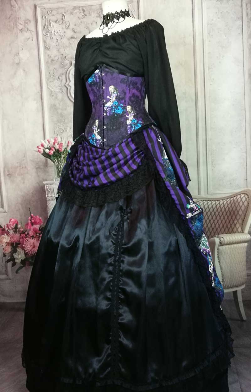 purple and black striped victorian bustle skirt featuring the characters from Alice in Wonderland, for wearing with a corset, made in Australia, shown with the matching corset and worn over a boned petticoat, front view