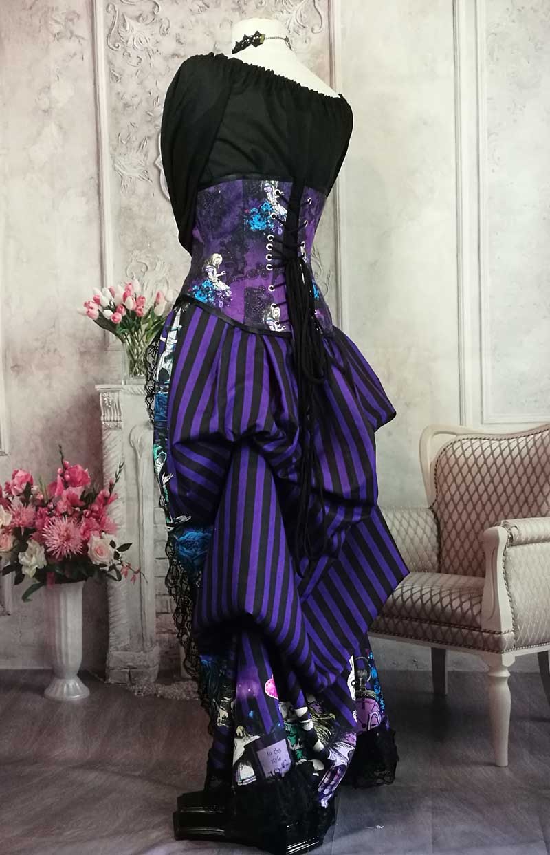 side back view of the purple and black striped victorian bustle skirt featuring the characters from Alice in Wonderland, for wearing with a corset, made in Australia, shown with the matching corset