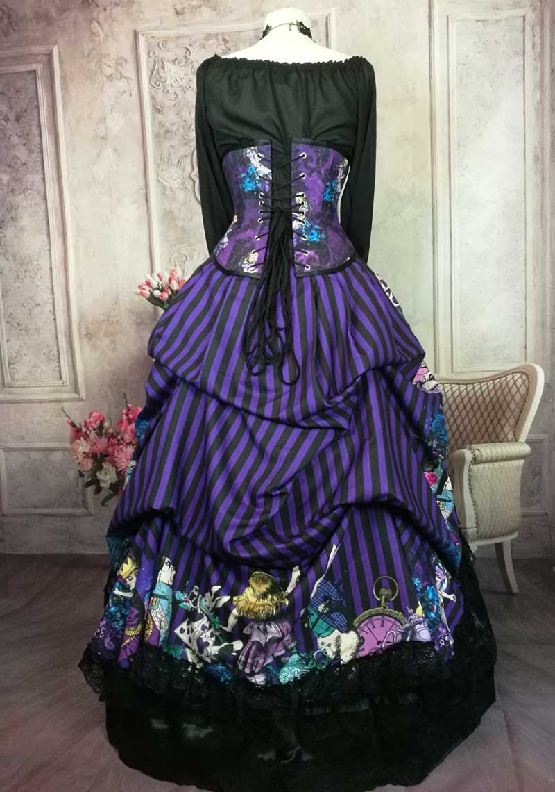 back view showing details of the Alice in Wonderland characters around the hem of the victorian bustle skirt and trimmed with black lace