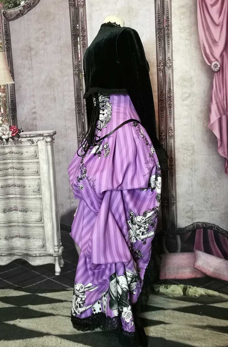 side view of the Violet coloured custom printed and made Alice in Wonderland fabric made into a steel boned under bust corset and matching  Victorian high low bustle skirt
