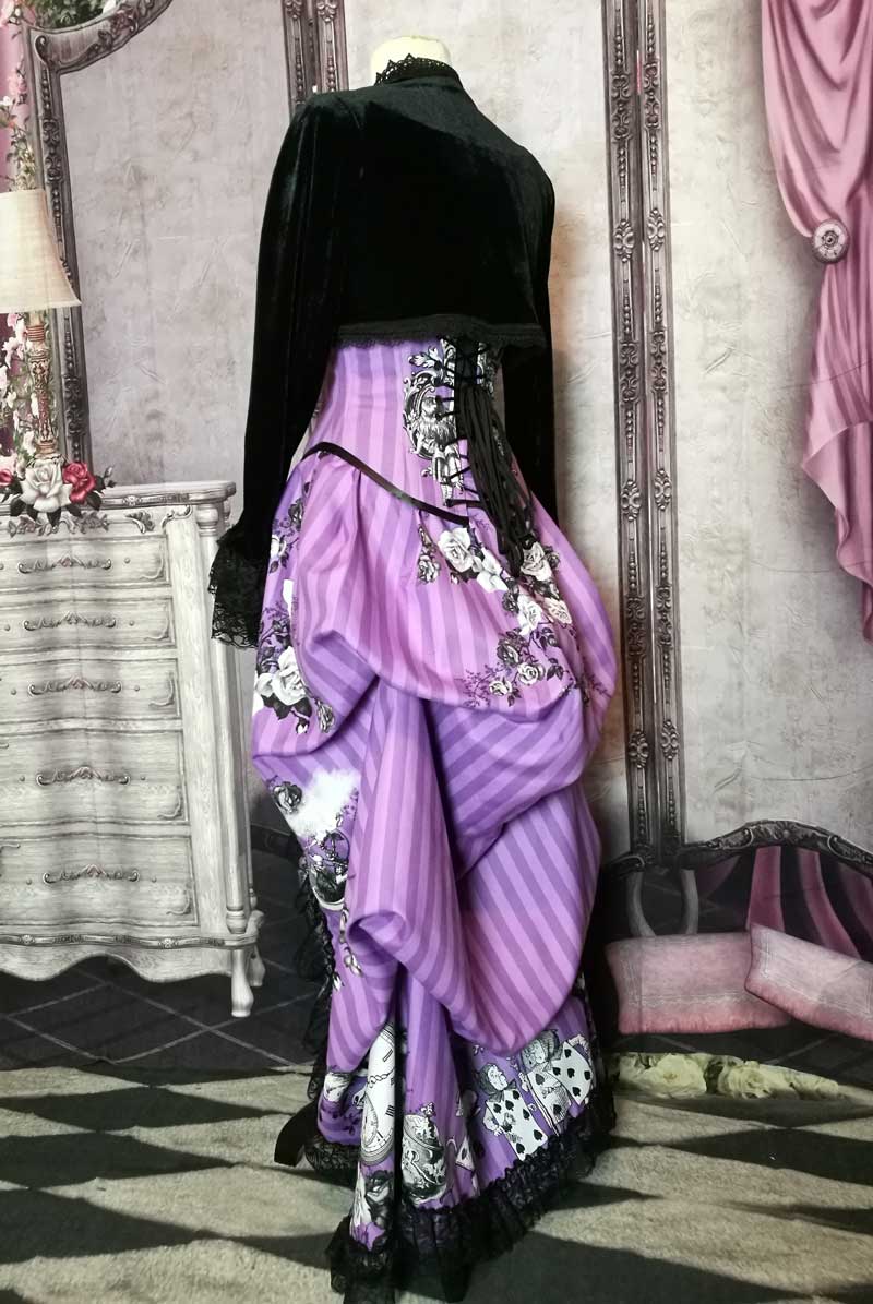 view of the bustle draping in the Violet coloured custom printed and made Alice in Wonderland fabric made into a steel boned under bust corset and matching  Victorian high low bustle skirt