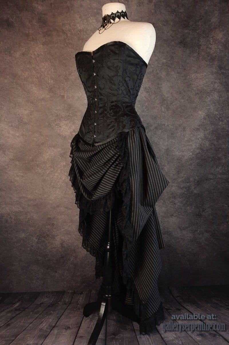 side front view of the Venus corset in black brocade worn with a victorian style bustle skirt in black & white pinstripe