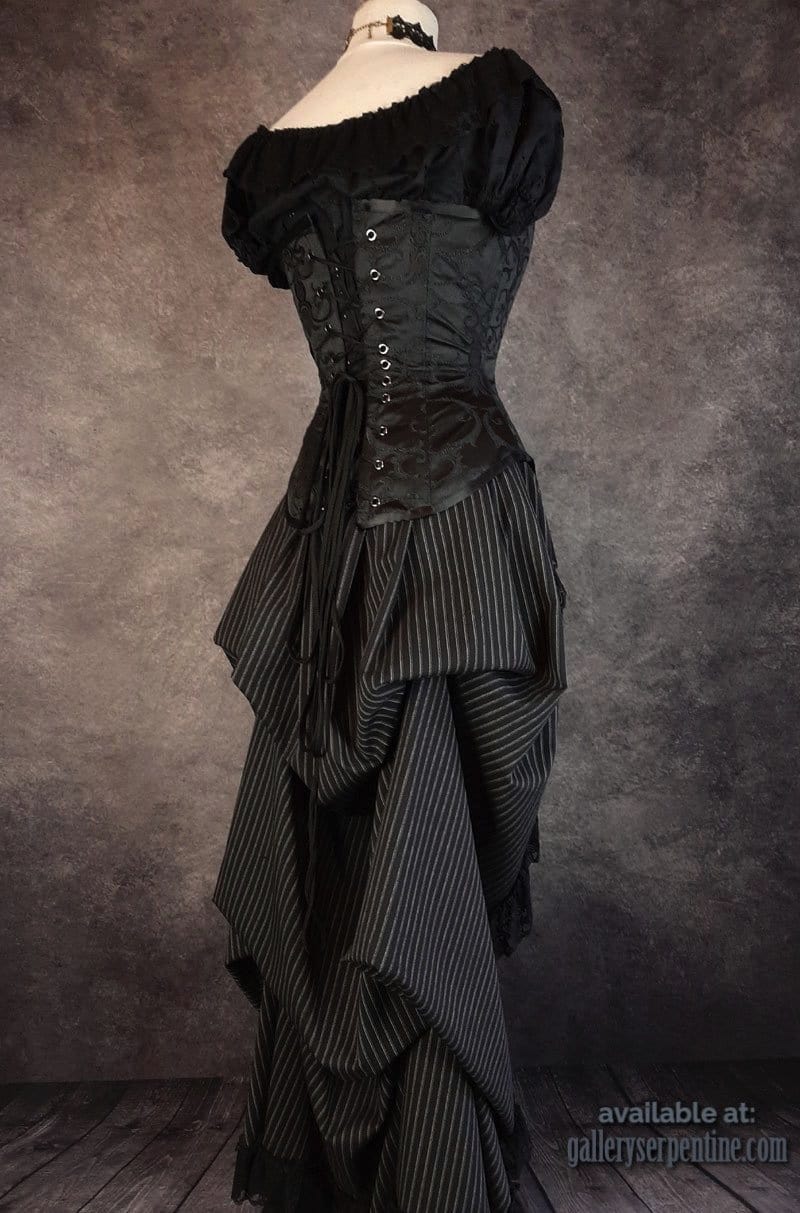 side back view of the Venus over bust corset worn with a pinstripe Victorian bustle skirt and black lace choker